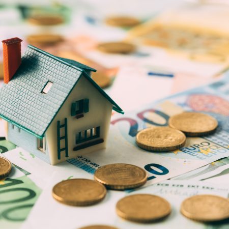 House model on cash stack closeup House model on cash stack closeup. Real estate property renting concept